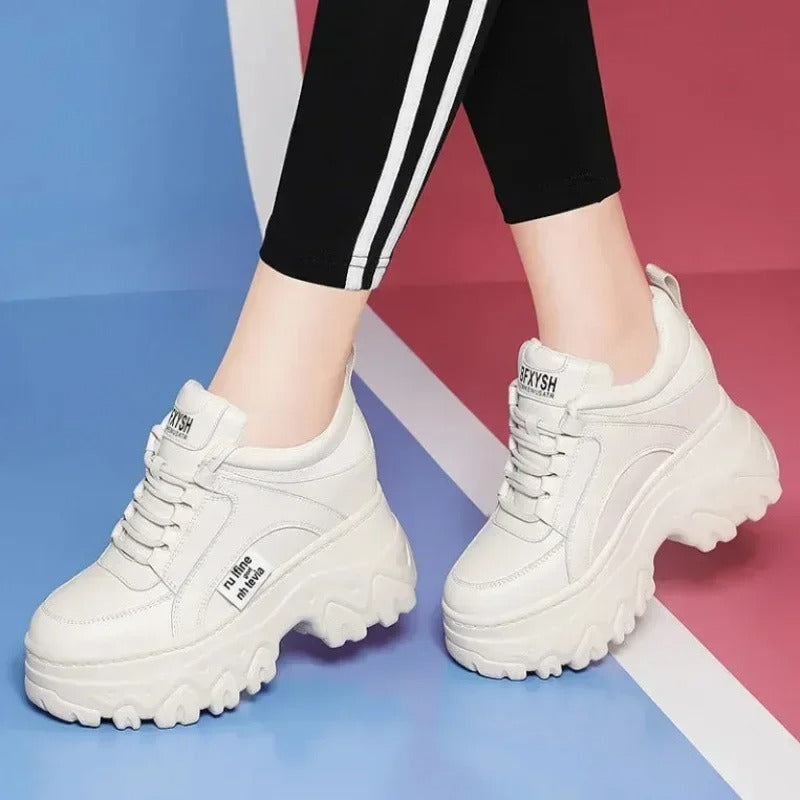 White fashionable women's sneakers on the platform