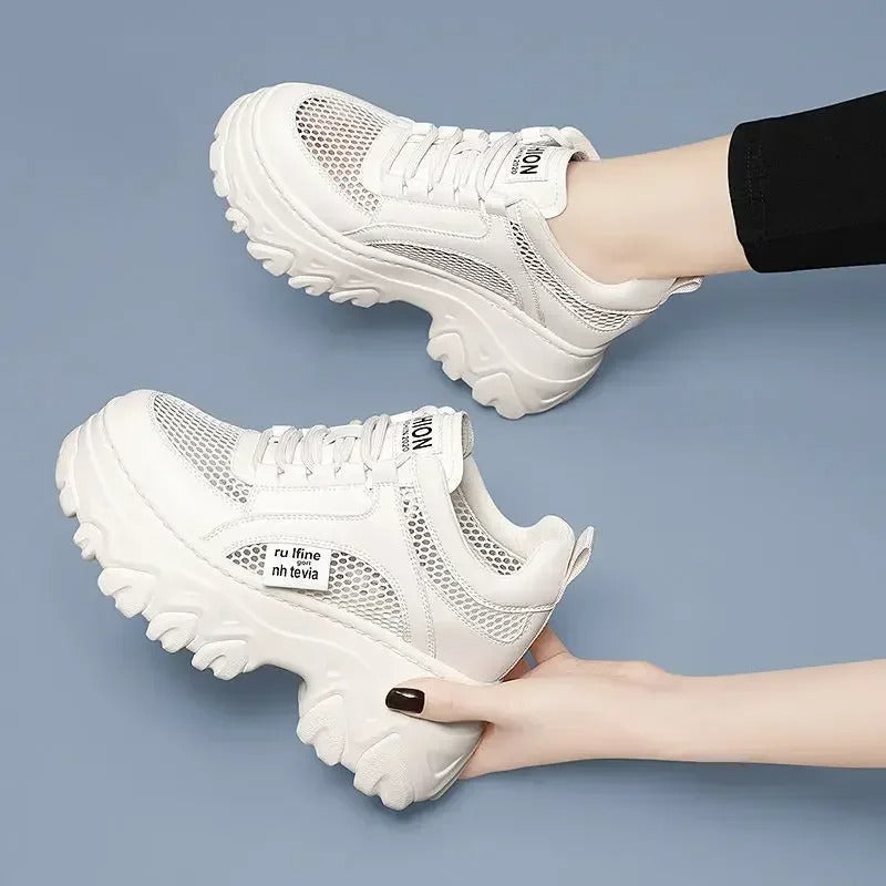 White fashionable mesh sneakers on the platform