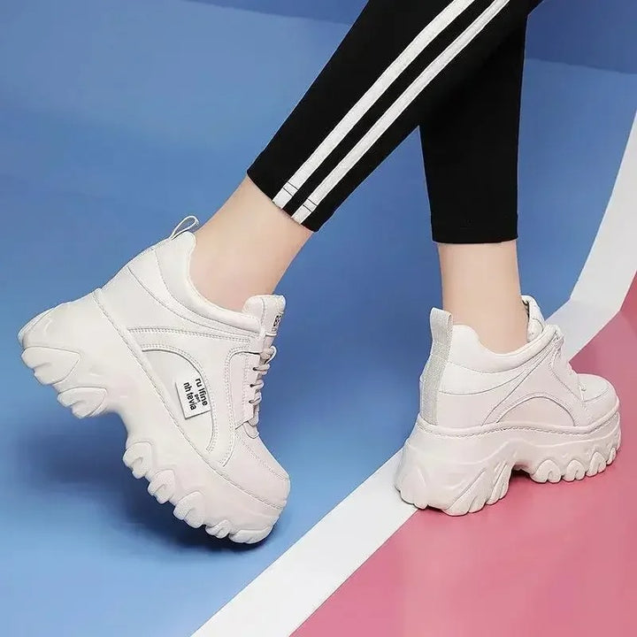 White fashionable women's sneakers on the platform